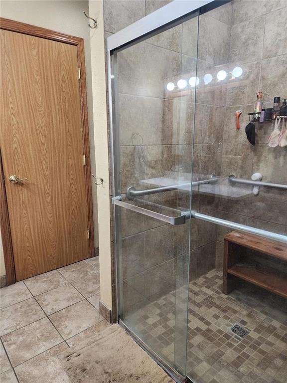 bathroom with a shower with door