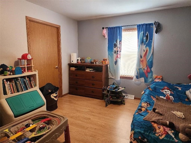 bedroom with light hardwood / wood-style flooring