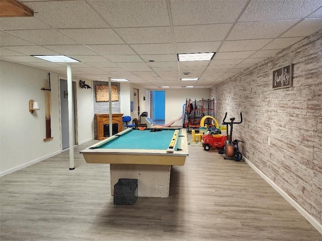 playroom featuring a drop ceiling and light wood-type flooring