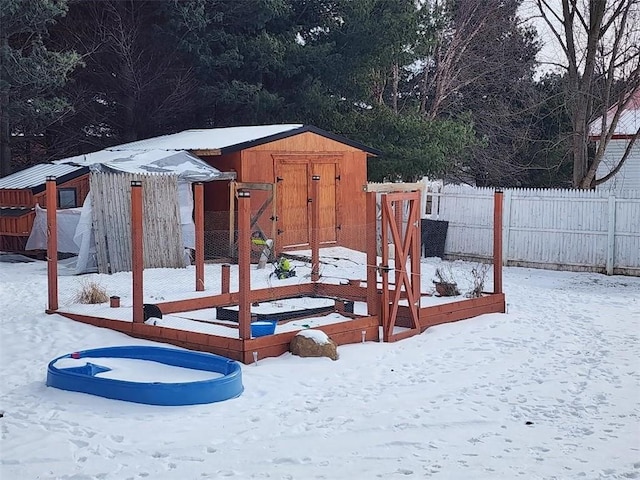 snow covered playground with a storage shed