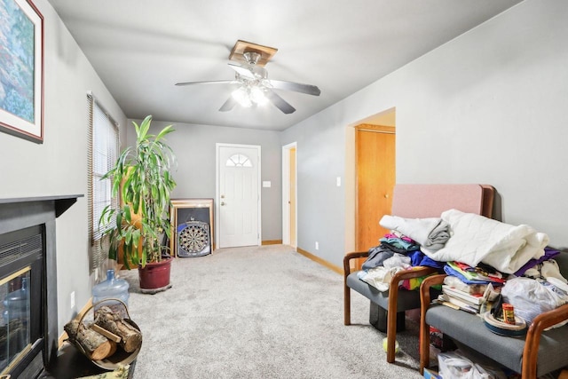 carpeted living room with ceiling fan