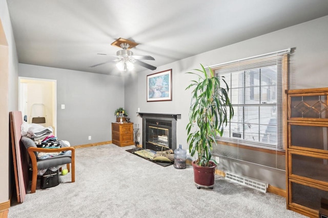 living area featuring carpet flooring and ceiling fan