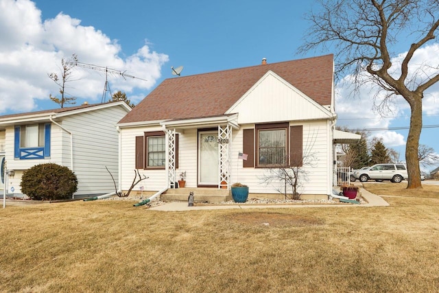 bungalow-style home with a front lawn