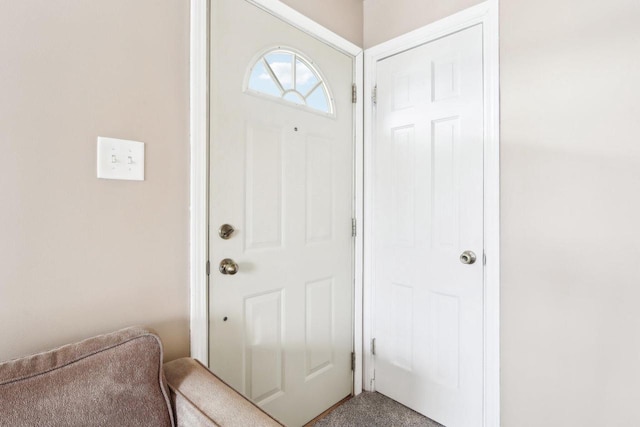 view of carpeted foyer entrance