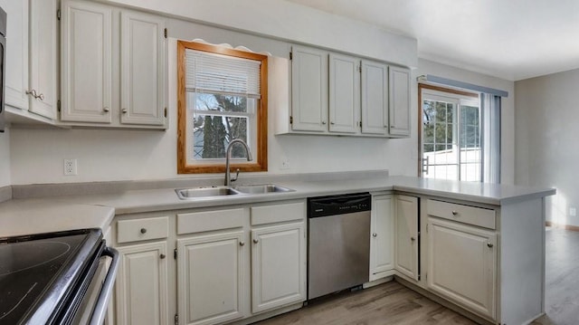 kitchen featuring white cabinetry, dishwasher, and sink