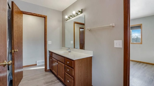 bathroom with vanity and hardwood / wood-style flooring