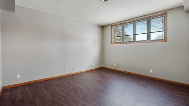 unfurnished room featuring dark hardwood / wood-style flooring