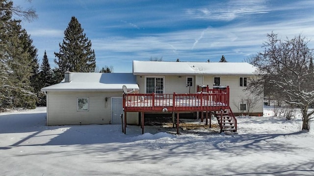 snow covered property featuring a wooden deck