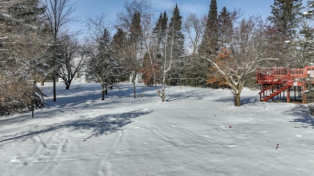 snowy yard with a wooden deck