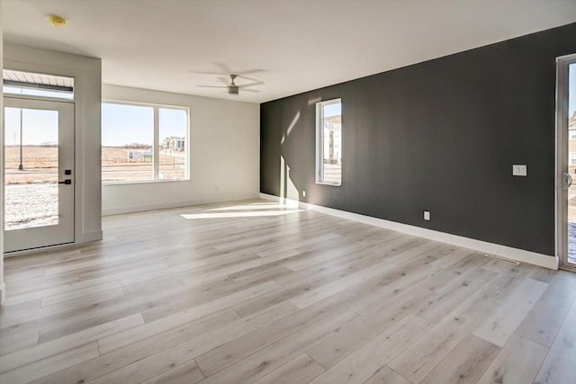 unfurnished room featuring ceiling fan and light wood-type flooring