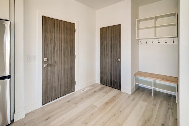 mudroom with light hardwood / wood-style floors