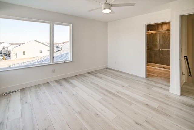 unfurnished bedroom with ensuite bathroom, ceiling fan, and light wood-type flooring