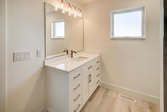 bathroom featuring vanity and hardwood / wood-style flooring