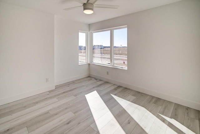 unfurnished room with ceiling fan and light hardwood / wood-style flooring