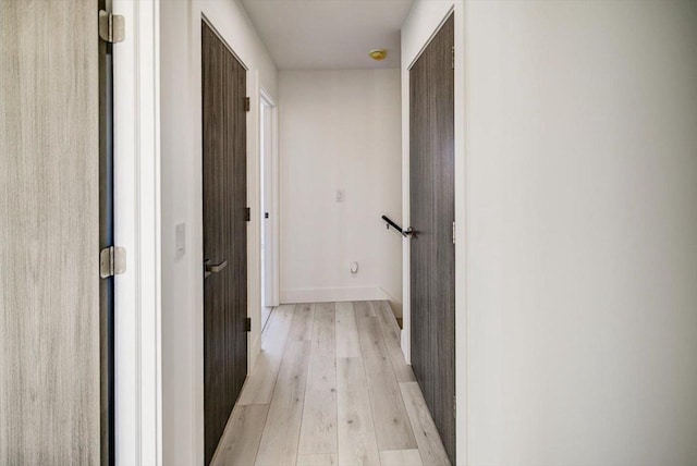 corridor with light wood-type flooring