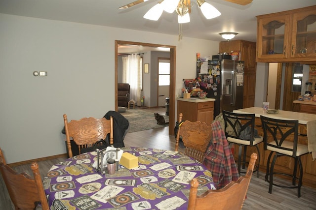 dining room featuring wood-type flooring and ceiling fan