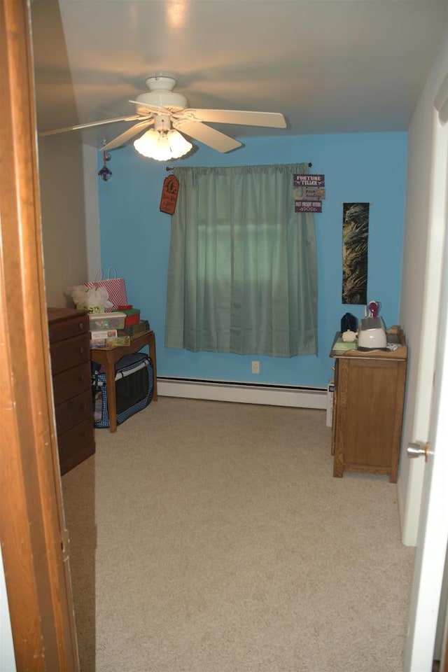 bedroom featuring ceiling fan, light carpet, and baseboard heating