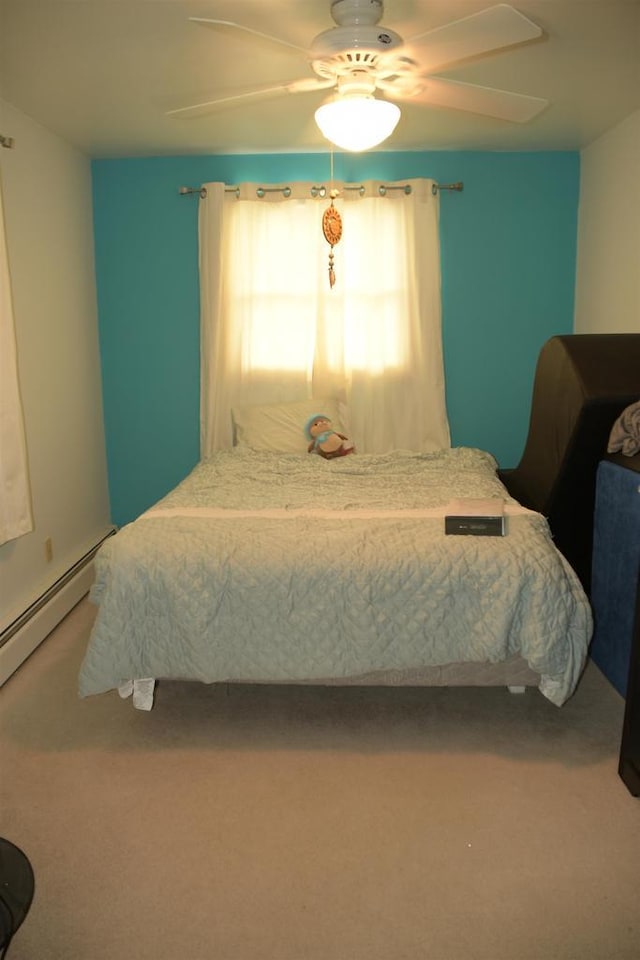 bedroom featuring a baseboard radiator, carpet, and ceiling fan