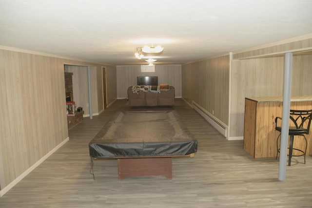 rec room featuring a baseboard heating unit, pool table, wooden walls, and light hardwood / wood-style floors