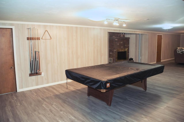 rec room with hardwood / wood-style floors, crown molding, billiards, and a brick fireplace