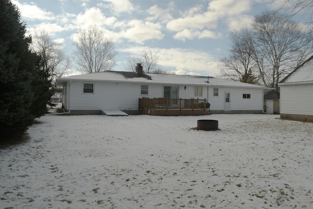 snow covered property with a wooden deck