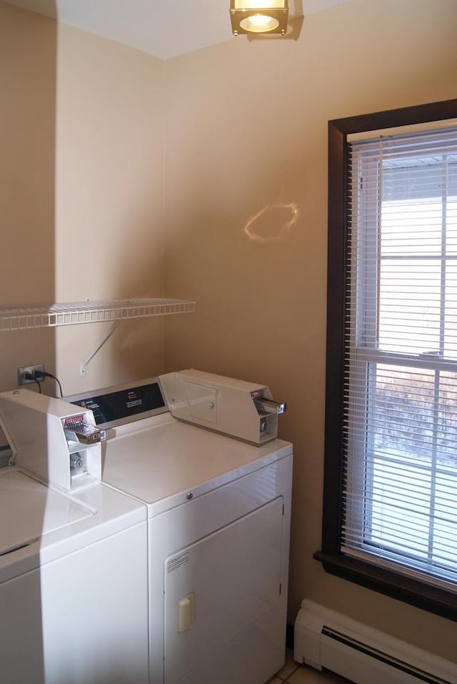 clothes washing area with tile patterned flooring, a baseboard heating unit, and washing machine and dryer