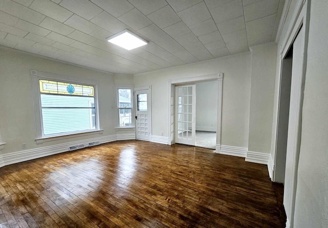 spare room with dark wood-type flooring