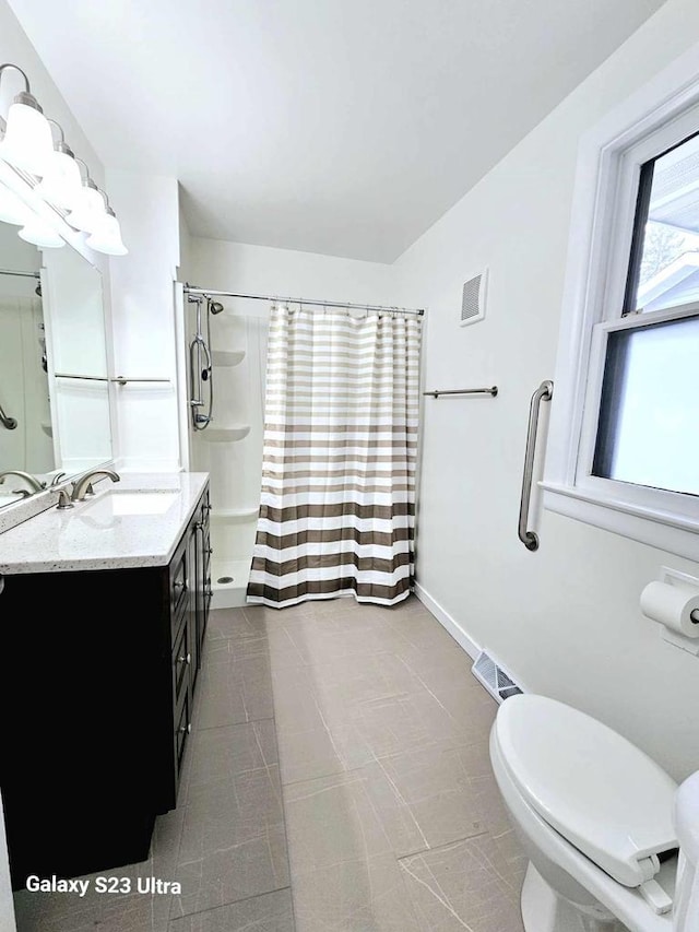 bathroom featuring a shower with curtain, vanity, toilet, and tile patterned flooring