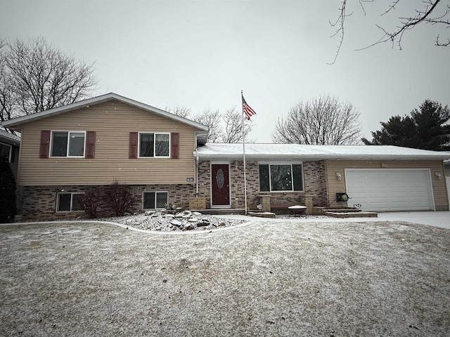 split level home with a garage and driveway