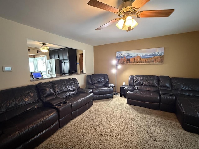 carpeted living area featuring a ceiling fan