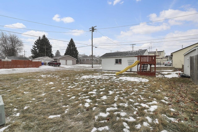 snowy yard with a playground