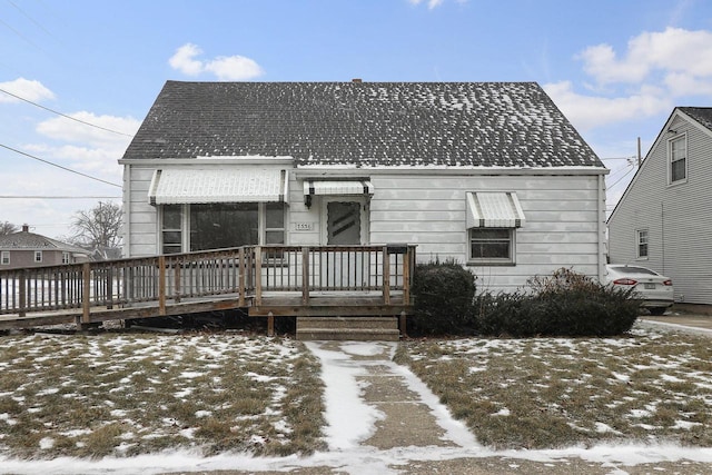 snow covered property with a wooden deck