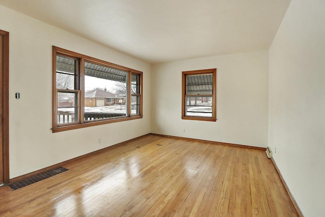 empty room with light hardwood / wood-style flooring