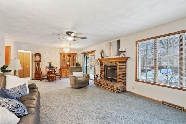 carpeted living room with ceiling fan, a healthy amount of sunlight, and a fireplace