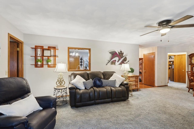 carpeted living room with ceiling fan