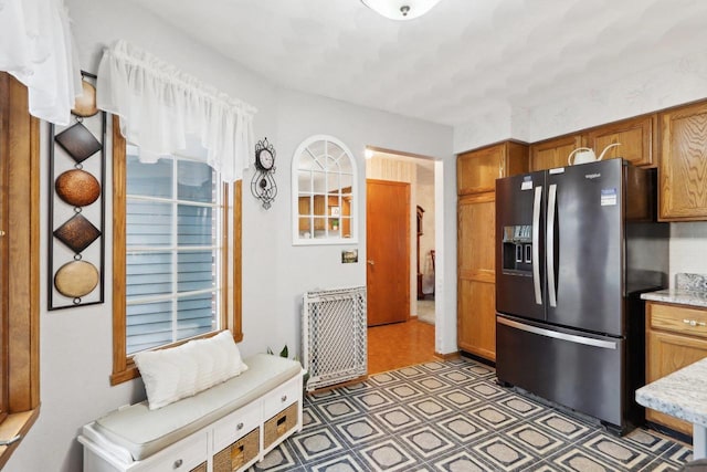 kitchen featuring black refrigerator with ice dispenser