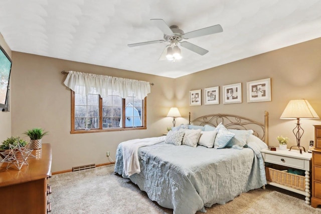 bedroom featuring light colored carpet and ceiling fan