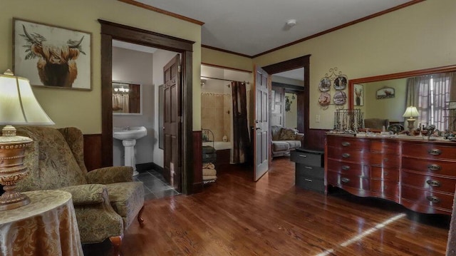 sitting room with ornamental molding and dark hardwood / wood-style floors