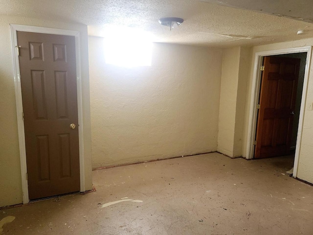 spare room with a textured ceiling