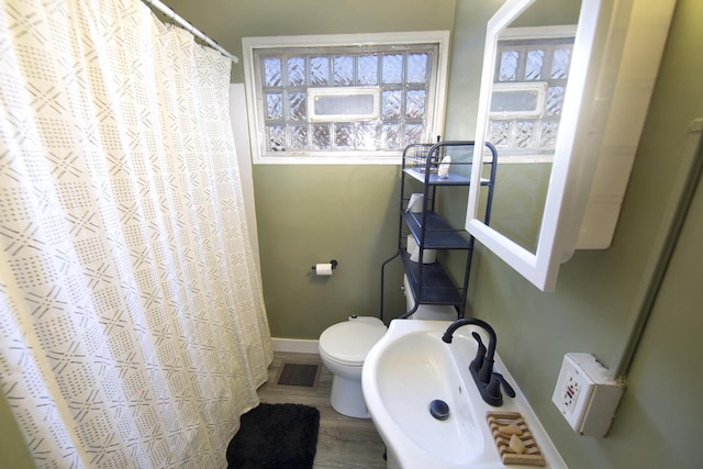 bathroom featuring hardwood / wood-style flooring, toilet, and sink