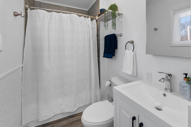 bathroom with hardwood / wood-style flooring, ornamental molding, vanity, and toilet