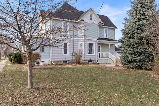 view of front facade with a front lawn and covered porch