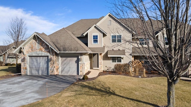 view of front of home featuring a garage and a front lawn