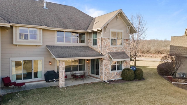 back of house featuring a patio area and a lawn