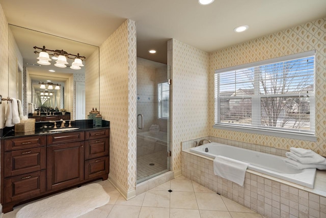 bathroom featuring tile patterned floors, vanity, and shower with separate bathtub