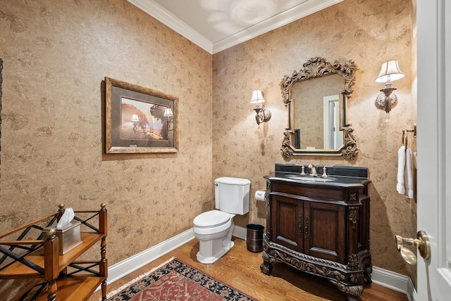 bathroom featuring crown molding, vanity, toilet, and hardwood / wood-style flooring