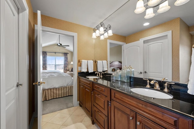 bathroom featuring vanity, tile patterned flooring, vaulted ceiling, and ceiling fan