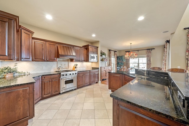 kitchen with premium range hood, decorative light fixtures, light tile patterned floors, stainless steel appliances, and backsplash