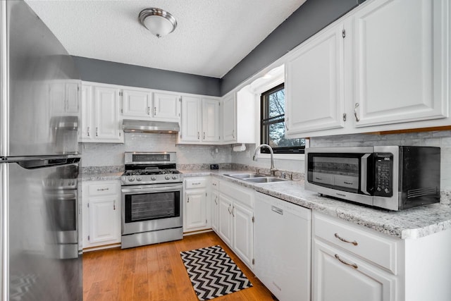 kitchen with white cabinetry, appliances with stainless steel finishes, sink, and a textured ceiling