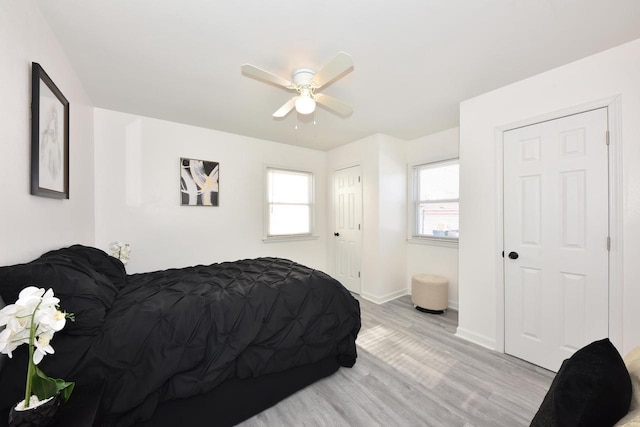 bedroom with light wood-type flooring and ceiling fan